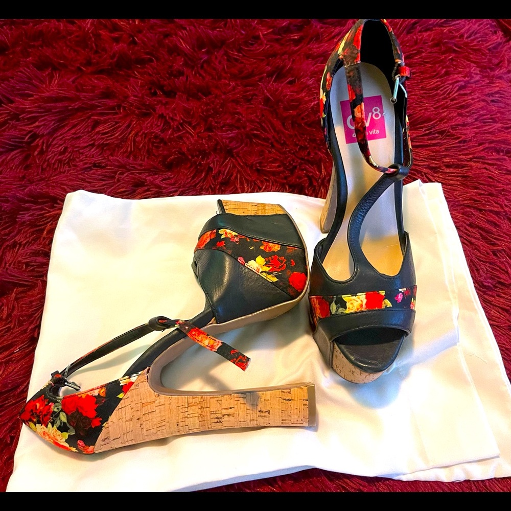 Beautiful black leathered flowered pattern platform shoes.